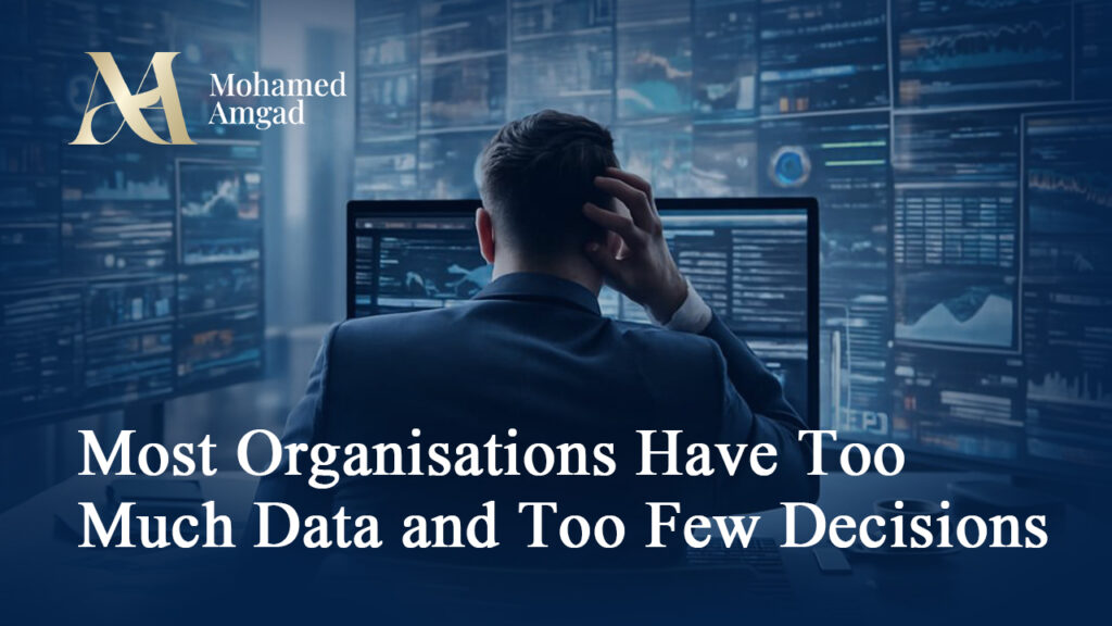 Analyst viewed from behind facing multiple monitors filled with data dashboards and charts